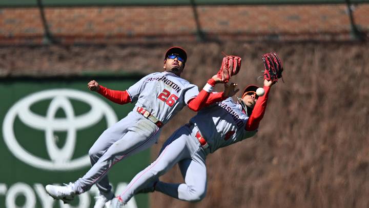 Mar 28, 2026; Chicago, Illinois, USA; Washington Nationals left fielder Daylen Lile (4) and shortstop Nasim Nunez (26) collide causing an error which allows two runs against the Chicago Cubs during the second inning at Wrigley Field. Mandatory Credit: Patrick Gorski-Imagn Images