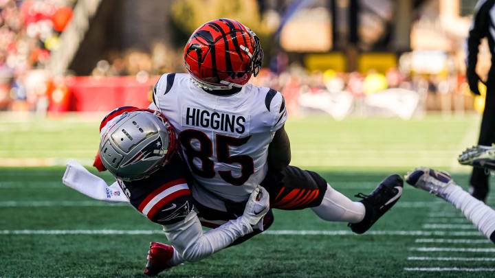 Dec 24, 2022; Foxborough, Massachusetts, USA; Cincinnati Bengals wide receiver Tee Higgins (85) makes a touchdown against New England Patriots cornerback Jonathan Jones (31) in the first quarter at Gillette Stadium. Mandatory Credit: David Butler II-USA TODAY Sports