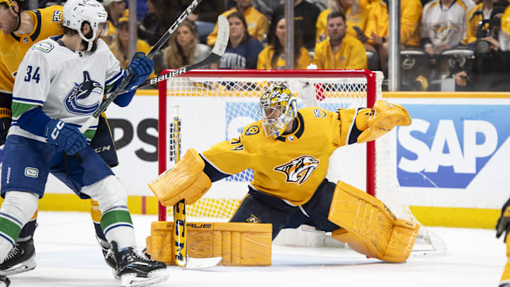 May 3, 2024; Nashville, Tennessee, USA; during the second period in game six of the first round of the 2024 Stanley Cup Playoffs at Bridgestone Arena. Mandatory Credit: Steve Roberts-Imagn ImagesNashville Predators goaltender Juuse Saros (74) blocks the puck against the Vancouver Canucks 