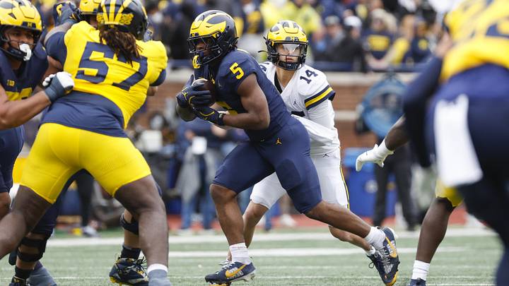 Apr 18, 2026; Ann Arbor, MI, USA; Michigan Wolverines quarterback Tommy Carr (14) hands the ball off to running back Savion Hiter on during the first half at Michigan Stadium. Mandatory Credit: Brian Bradshaw Sevald-Imagn Images