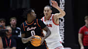 Jan 11, 2025; Salt Lake City, Utah, USA; Oklahoma State Cowboys forward Marchelus Avery (0) moves the ball against Utah Utes forward Keanu Dawes (8) during the second half at Jon M. Huntsman Center. Mandatory Credit: Rob Gray-Imagn Images