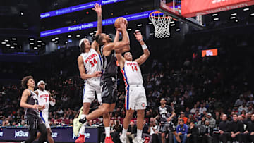 Jan 8, 2025; Brooklyn, New York, USA;  Brooklyn Nets forward Tosan Evbuomwan (12) looks to drive past Detroit Pistons forward Bobi Klintman (34): Wendell Cruz-Imagn Images