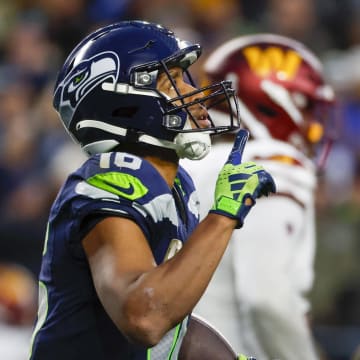 Nov 12, 2023; Seattle, Washington, USA; Seattle Seahawks wide receiver Tyler Lockett (16) reacts after catching a touchdown pass against the Washington Commanders during the fourth quarter at Lumen Field.