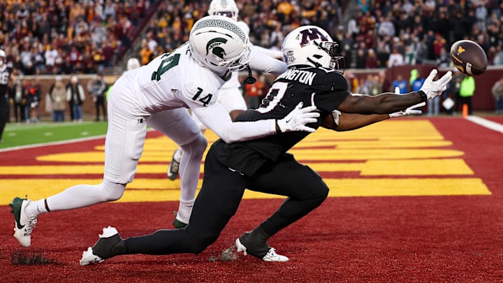 Nov 1, 2025; Minneapolis, Minnesota, USA; Michigan State Spartans defensive back Malcolm Bell (14) commits a pass interference penalty against Minnesota Golden Gophers wide receiver Lemeke Brockington (0) during overtime at Huntington Bank Stadium.