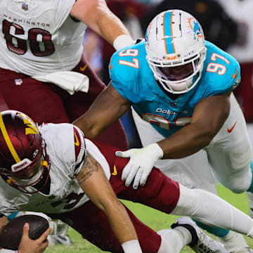 Miami Dolphins defensive tackle Isaiah Mack sacks Washington Commanders quarterback Trace McSorley.