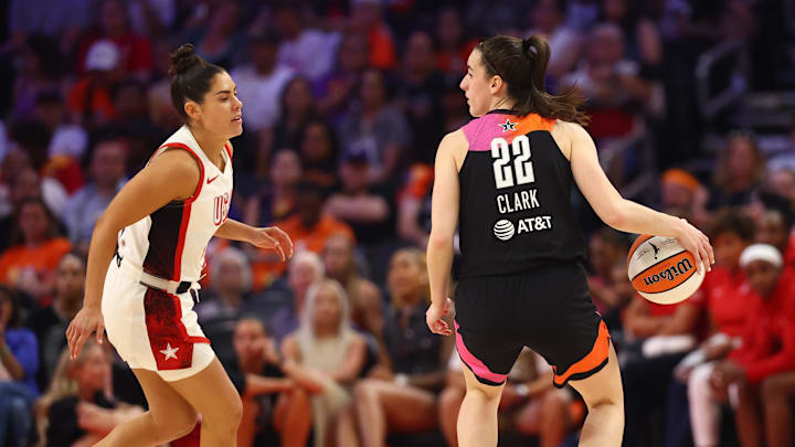 Jul 20, 2024; Phoenix, AZ, USA; Team WNBA guard Caitlin Clark (22) against USA Women's National Team player Kelsey Plum (5) at Footprint Center. Mandatory Credit: Mark J. Rebilas-Imagn Images