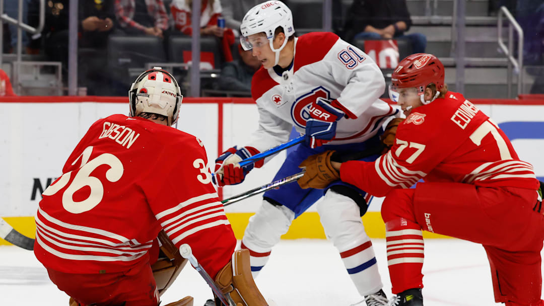 Oct 9, 2025; Detroit, Michigan, USA;  Detroit Red Wings goaltender John Gibson (36) makes the save on Montréal Canadiens center Oliver Kapanen (91) in the first period at Little Caesars Arena. Mandatory Credit: Rick Osentoski-Imagn Images