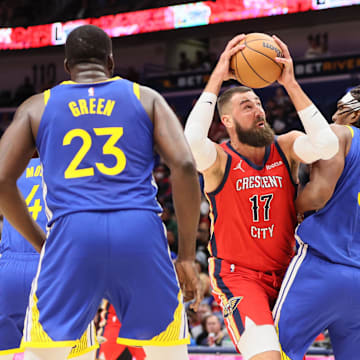 Oct 30, 2023; New Orleans, Louisiana, USA; New Orleans Pelicans center Jonas Valanciunas (17) tries to power past Golden State Warriors forward Kevon Looney (5) for a shot in the first quarter at Smoothie King Center. Mandatory Credit: Matthew Dobbins-Imagn Images