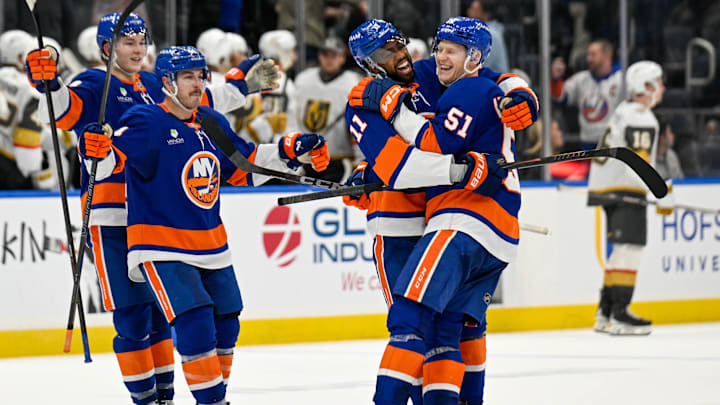 Dec 9, 2025; Elmont, New York, USA; New York Islanders left wing Emil Heineman (51) celebrates his winning goal with New York Islanders left wing Anthony Duclair (11) after shootouts against the Vegas Golden Knights at UBS Arena. Mandatory Credit: Dennis Schneidler-Imagn Images