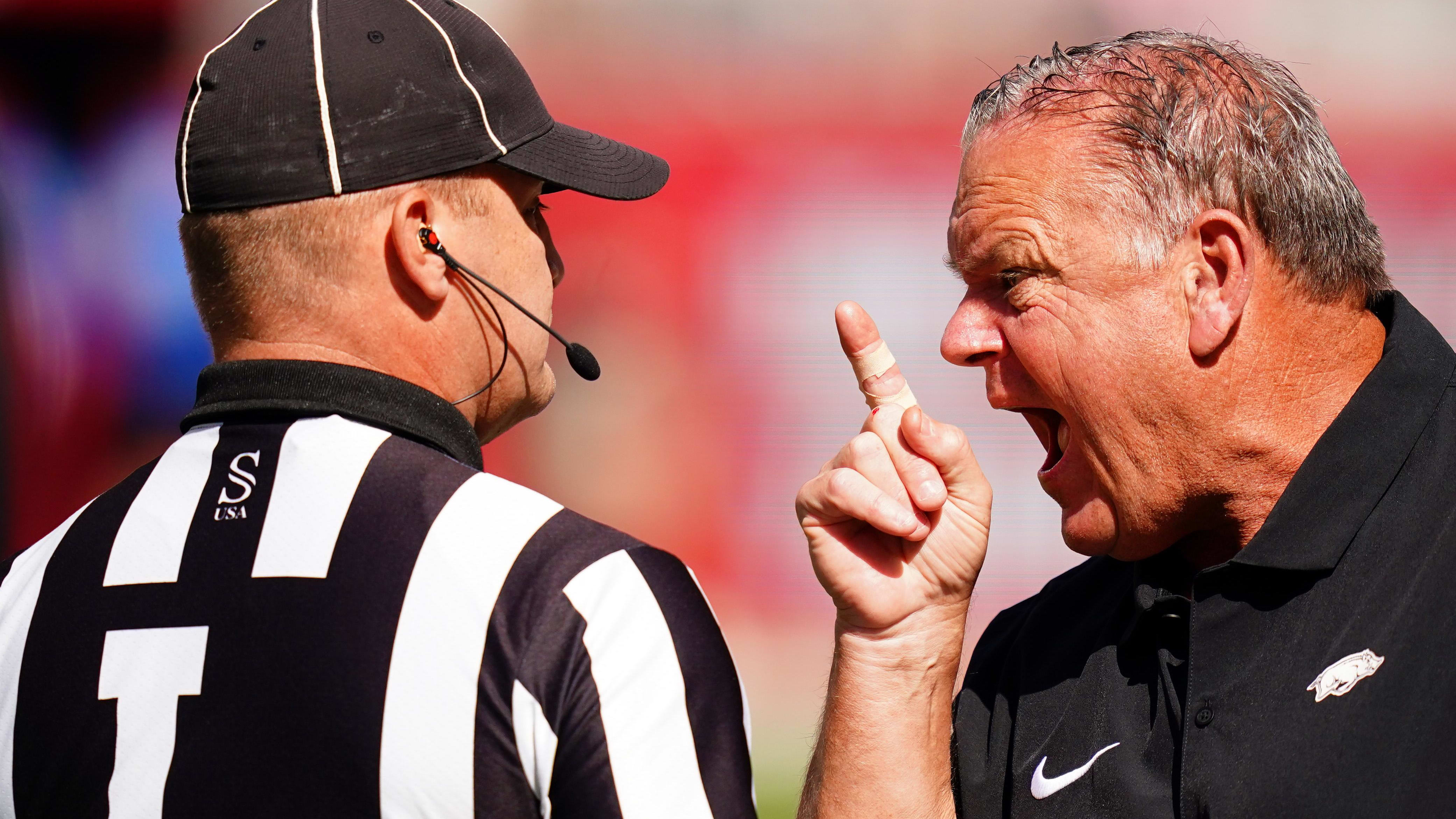 Arkansas coach Sam Pittman yells in the face of a referee.