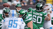 Dec 18, 2022; East Rutherford, New Jersey, USA; New York Jets quarterback Zach Wilson (2) throws the ball  as center Connor McGovern (60) blocks during the first quarter against the Detroit Lions at MetLife Stadium. 