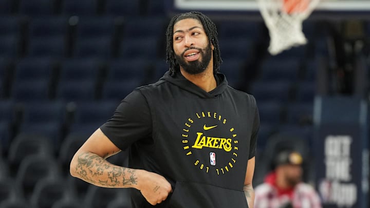 Davis walks on the court before a game. Davis walks on the court before a game.