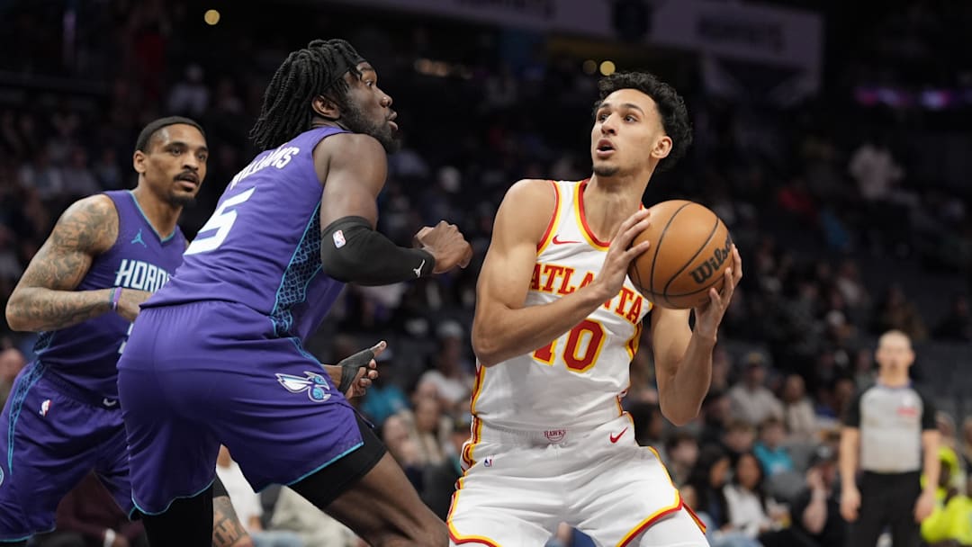 Mar 18, 2025; Charlotte, North Carolina, USA; Atlanta Hawks forward Zaccharie Risacher (10) looks to shoot guarded by Charlotte Hornets center Mark Williams (5) during first quarter at Spectrum Center. Mandatory Credit: Jim Dedmon-Imagn Images