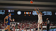 Dec 29, 2024; Tuscaloosa, Alabama, USA; Alabama Crimson Tide guard Aden Holloway (2) shoots against South Dakota State Jackrabbits guard Joe Sayler (3) during the second half at Coleman Coliseum. Mandatory Credit: Will McLelland-Imagn Images