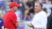 Oct 4, 2024; Fort Worth, Texas, USA; (Left to Right) Houston Cougars head coach Willie Fritz talks to TCU Horned Frogs head coach Sonny Dykes before the game at Amon G. Carter Stadium. Mandatory Credit: Tim Heitman-Imagn Images