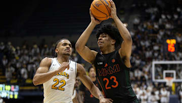 Jan 25, 2025; Berkeley, California, USA; Miami Hurricanes guard Austin Swartz (23) drives to the basket against California Golden Bears guard Christian Tucker (22) during the first half at Haas Pavilion. Mandatory Credit: D. Ross Cameron-Imagn Images