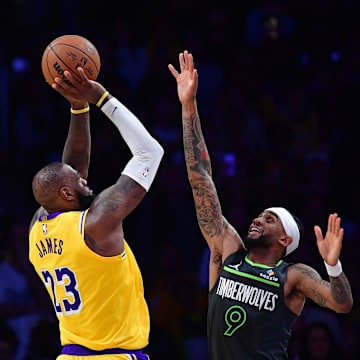 Apr 30, 2025; Los Angeles, California, USA; Los Angeles Lakers forward LeBron James (23) shoots against Minnesota Timberwolves guard Nickeil Alexander-Walker (9) during the second half in game five of first round for the 2025 NBA Playoffs at Crypto.com Arena. Mandatory Credit: Gary A. Vasquez-Imagn Images