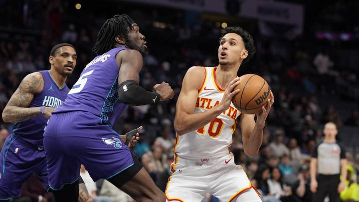 Mar 18, 2025; Charlotte, North Carolina, USA; Atlanta Hawks forward Zaccharie Risacher (10) looks to shoot guarded by Charlotte Hornets center Mark Williams (5) during first quarter at Spectrum Center. Mandatory Credit: Jim Dedmon-Imagn Images