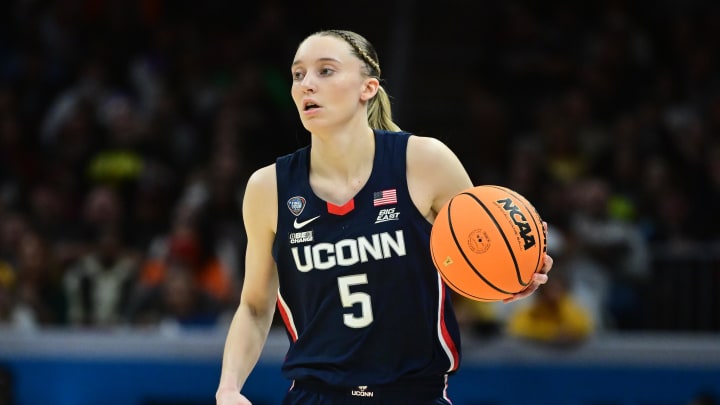 Apr 5, 2024; Cleveland, OH, USA; Connecticut Huskies guard Paige Bueckers (5) dribbles the ball against the Iowa Hawkeyes in the semifinals of the Final Four of the womens 2024 NCAA Tournament at Rocket Mortgage FieldHouse.