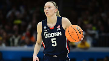 Apr 5, 2024; Cleveland, OH, USA; Connecticut Huskies guard Paige Bueckers (5) dribbles the ball against the Iowa Hawkeyes in the semifinals of the Final Four of the womens 2024 NCAA Tournament at Rocket Mortgage FieldHouse. Mandatory Credit: Ken Blaze-Imagn Images