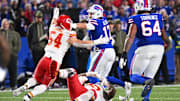 Nov 2, 2025; Orchard Park, New York, USA; Buffalo Bills quarterback Josh Allen (17) stiff arms Kansas City Chiefs linebacker Leo Chenal (54) in the second half at Highmark Stadium. Mandatory Credit: Mark Konezny-Imagn Images