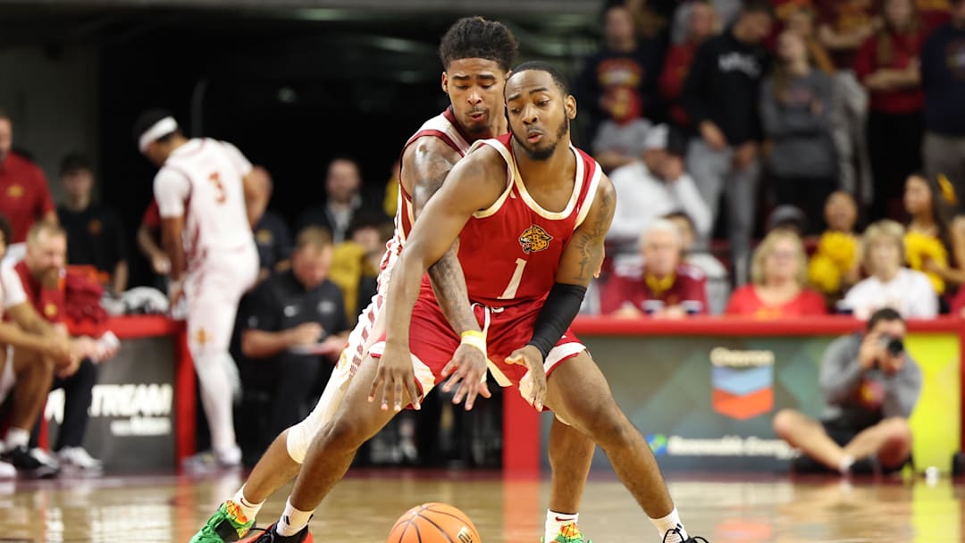 Nov 18, 2024; Ames, Iowa, USA; IUPUI Jaguars guard Alec Millender (1) is fouled by Iowa State Cyclones guard Keshon Gilbert (10) in the second half at James H. Hilton Coliseum. Mandatory Credit: Reese Strickland-Imagn Images