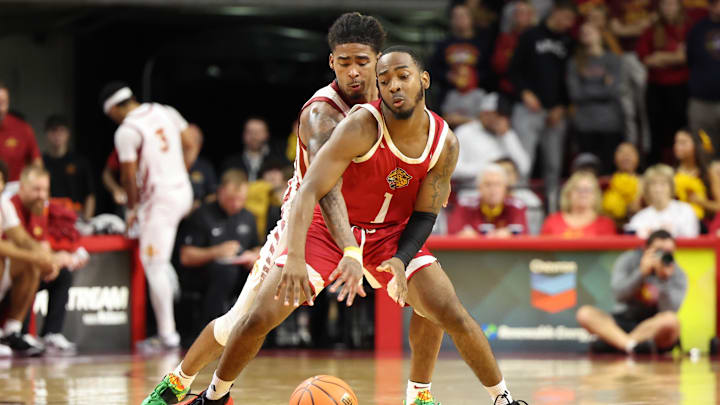 Nov 18, 2024; Ames, Iowa, USA; IUPUI Jaguars guard Alec Millender (1) is fouled by Iowa State Cyclones guard Keshon Gilbert (10) in the second half at James H. Hilton Coliseum. Mandatory Credit: Reese Strickland-Imagn Images