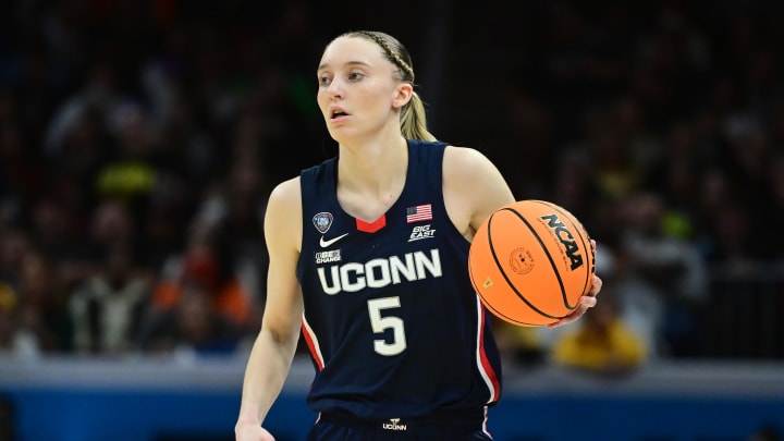 Apr 5, 2024; Cleveland, OH, USA; Connecticut Huskies guard Paige Bueckers (5) dribbles the ball against the Iowa Hawkeyes in the semifinals of the Final Four of the womens 2024 NCAA Tournament at Rocket Mortgage FieldHouse. Mandatory Credit: Ken Blaze-USA TODAY Sports