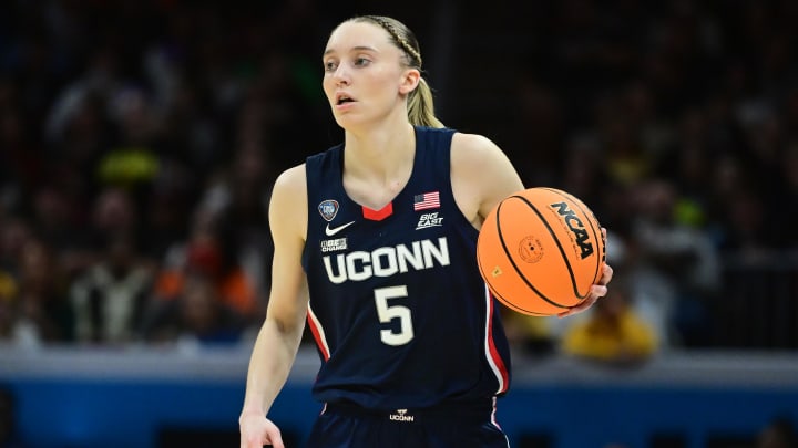 Apr 5, 2024; Cleveland, OH, USA; Connecticut Huskies guard Paige Bueckers (5) dribbles the ball against the Iowa Hawkeyes in the semifinals of the Final Four of the womens 2024 NCAA Tournament at Rocket Mortgage FieldHouse. Mandatory Credit: Ken Blaze-USA TODAY Sports