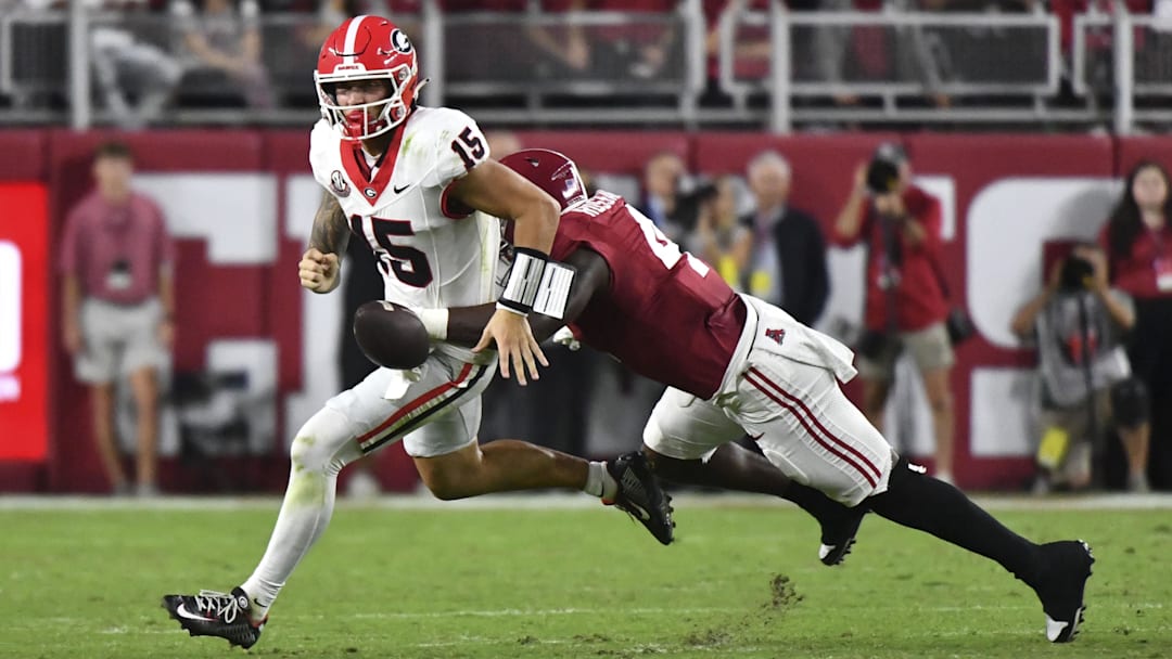 Alabama Crimson Tide defensive back Keon Sabb (3) strips the ball from Georgia Bulldogs quarterback Carson Beck (15)