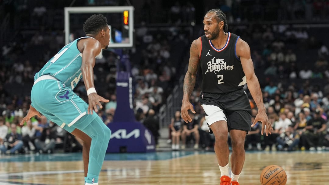 Mar 31, 2024; Charlotte, North Carolina, USA; LA Clippers forward Kawhi Leonard (2) on the dribble against Charlotte Hornets forward Brandon Miller (24) during the second half at Spectrum Center. Mandatory Credit: Jim Dedmon-USA TODAY Sports