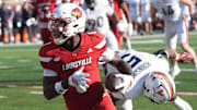 Louisville’s Chris Bell makes Virginia’s Kam Robinson miss and scores a touchdown at L&N Stadium Saturday.
Ocr. 4, 2025