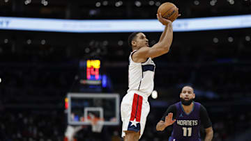 Dec 19, 2024; Washington, District of Columbia, USA; Washington Wizards guard Malcolm Brogdon (15) shoots the ball as Charlotte Hornets forward Cody Martin (11) looks on in the third quarter at Capital One Arena. Mandatory Credit: Geoff Burke-Imagn Images