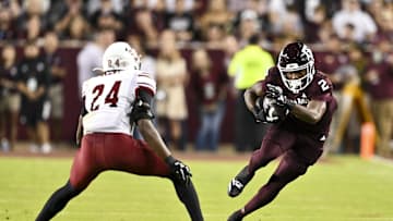 Nov 16, 2024; College Station, Texas, USA; Texas A&M Aggies wide receiver Terry Bussey (2) runs the ball as New Mexico State Aggies cornerback Dakerric Hobbs (24) defends during the first half at Kyle Field. Mandatory Credit: Maria Lysaker-Imagn Images 