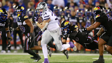 Kansas State junior tight end Ben Sinnott (34) drives through Kansas defenders during the first quarter of Saturday's Sunflower Showdown against Kansas inside David Booth Kansas Memorial Stadium.