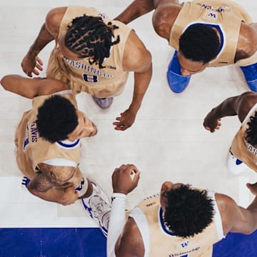 The Huskies gather before plays resumes at Alaska Airlines Arena.