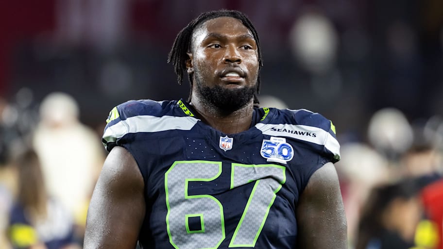 Seahawks tackle Charles Cross with no helmet on.