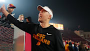 Nov 29, 2025; Los Angeles, California, USA; Southern California Trojans head coach Lincoln Riley celebrates with fans after the game against the UCLA Bruins at United Airlines Field at Los Angeles Memorial Coliseum. Mandatory Credit: Kirby Lee-Imagn Images
