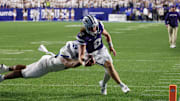 Sep 21, 2024; Provo, Utah, USA; Kansas State Wildcats quarterback Avery Johnson (2) is pursued by Brigham Young Cougars defensive end Logan Lutui (59) during the third quarter at LaVell Edwards Stadium. Mandatory Credit: Rob Gray-Imagn Images