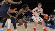 Mar 11, 2025; Charlotte, NC, USA; Virginia Tech Hokies guard Brandon Rechsteiner (7) handles the ball against California Golden Bears guard DJ Campbell (3) and center Mady Sissoko (12) during OT at Spectrum Center. Mandatory Credit: Jim Dedmon-Imagn Images