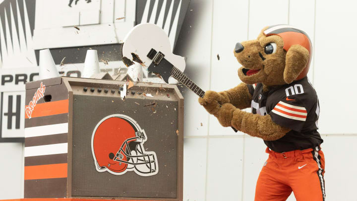 The Cleveland Browns mascot Chomps smashes a guitar on the steps of the Pro Football Hall of Fame to open newest Hall of Fame exhibit, A Legacy Unleashed.