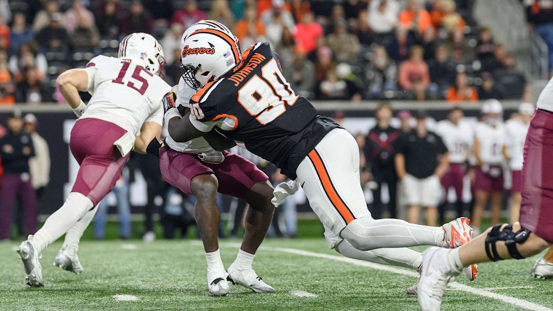 Oct 18, 2025; Corvallis, Oregon, USA; Oregon State Beavers defensive lineman Jojo Johnson (90) stops Lafayette Leopards running back Jakyre Henley (5) behind the line of scrimmage during the fourth quarter at Reser Stadium. Mandatory Credit: Craig Strobeck-Imagn Images