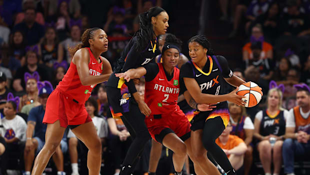 A photo of Monique Akoa Makani receives a screen from DeWanna Bonner