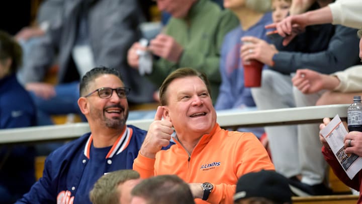 Illini head coach Brad Underwood, in orange, and associate head coach Orlando Antigua greets fans at the Class 3A Washington Sectional semifinal Tuesday, March 4, 2025 at Washington Community High School. The Redbirds' rallied to defeat Kankakee 65-63 in overtime.