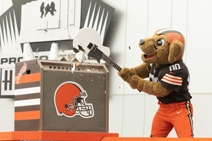 Cleveland Browns mascot Chomps smashes a guitar on the steps of the Pro Football Hall of Fame to open newest exhibi