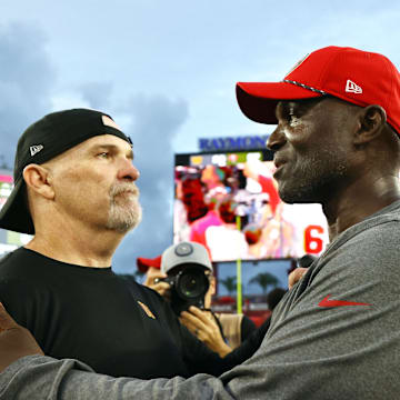 Sep 8, 2024; Tampa, Florida, USA; Washington Commanders head coach Dan Quinn and Tampa Bay Buccaneers head coach Todd Bowles greets after the game at Raymond James Stadium. Mandatory Credit: Kim Klement Neitzel-Imagn Images