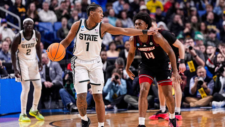 Michigan State guard Jeremy Fears Jr. (1) looks to pass against Louisville guard Adrian Wooley (14) during the first half of NCAA Tournament Second Round at KeyBank Center in Buffalo on Saturday, March 21, 2026.
