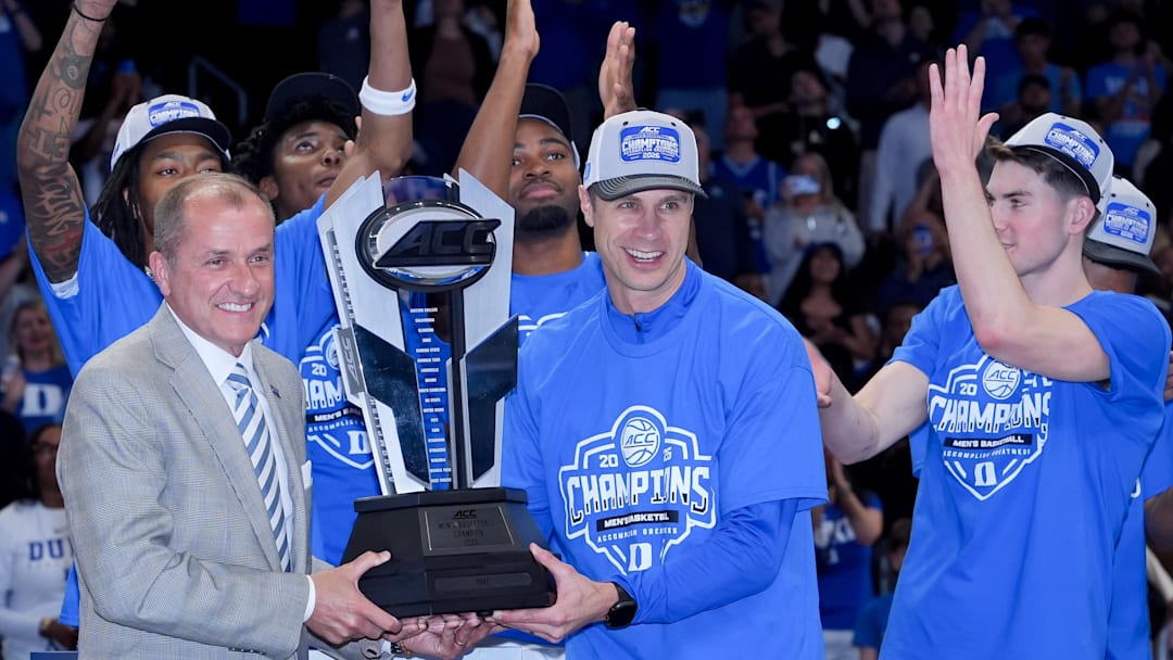Mar 14, 2026; Charlotte, NC, USA; Duke Blue Devils head coach Jon Scheyer receives the trophy after defeating the Virginia Cavaliers in the men's ACC Conference Tournament Championship.