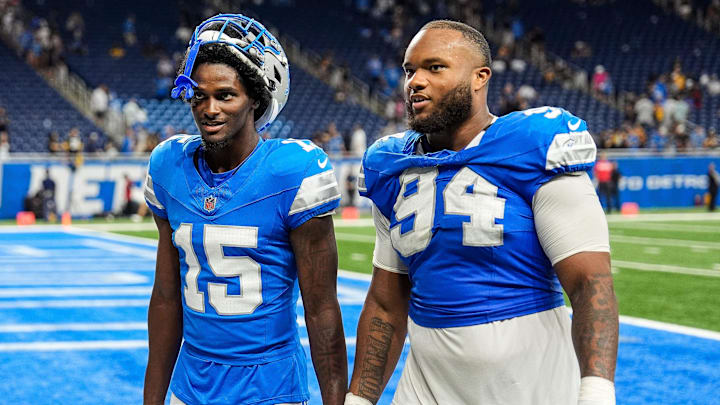 Detroit Lions cornerback Ennis Rakestraw Jr. (15), left, talks to defensive tackle Mekhi Wingo (94) 