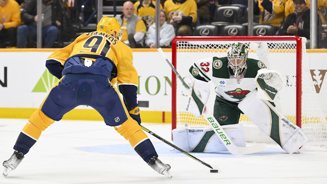 Feb 4, 2026; Nashville, Tennessee, USA;  Minnesota Wild goaltender Filip Gustavsson (32) blocks the shot of Nashville Predators center Steven Stamkos (91) during the first period at Bridgestone Arena. Mandatory Credit: Steve Roberts-Imagn Images